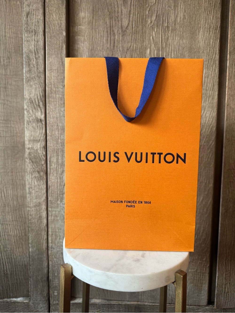 Louis Vuitton Orange Shopping Bag with Blue Handles and Black Logo